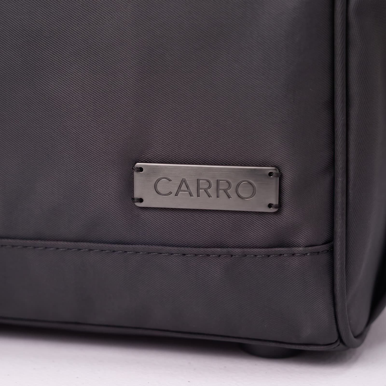 Close-up of the brushed metal CARRO plate on The Original in Matte Black